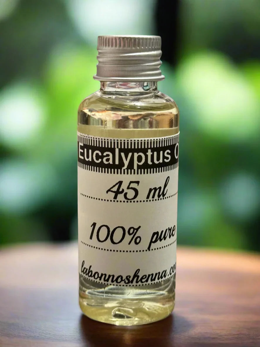 Clear glass bottle of 100% pure eucalyptus oil 45ml on a wooden surface, natural background